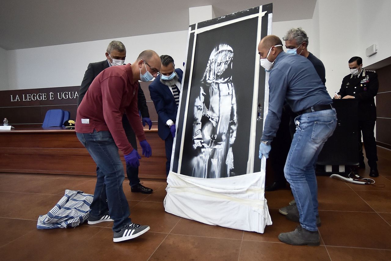 Italian police <a href="https://www.cnn.com/style/article/banksy-stolen-bataclan-artwork-found-in-italy-trnd/index.html" target="_blank">have found a Banksy artwork that was stolen</a> from outside the Bataclan theater in Paris last year. Banksy painted the mural on the exit door of the theater following the November 2015 terrorist attack on the Bataclan, which killed 90 people. It depicts a sad-looking veiled figure gazing downward, and it is believed to be a tribute to the survivors of that attack.