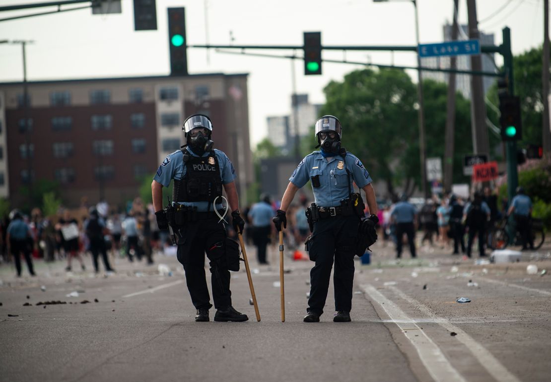 Two police officers stand outside the Third Police Precinct during the "I Can't Breathe" protest on May 27 in Minneapolis.