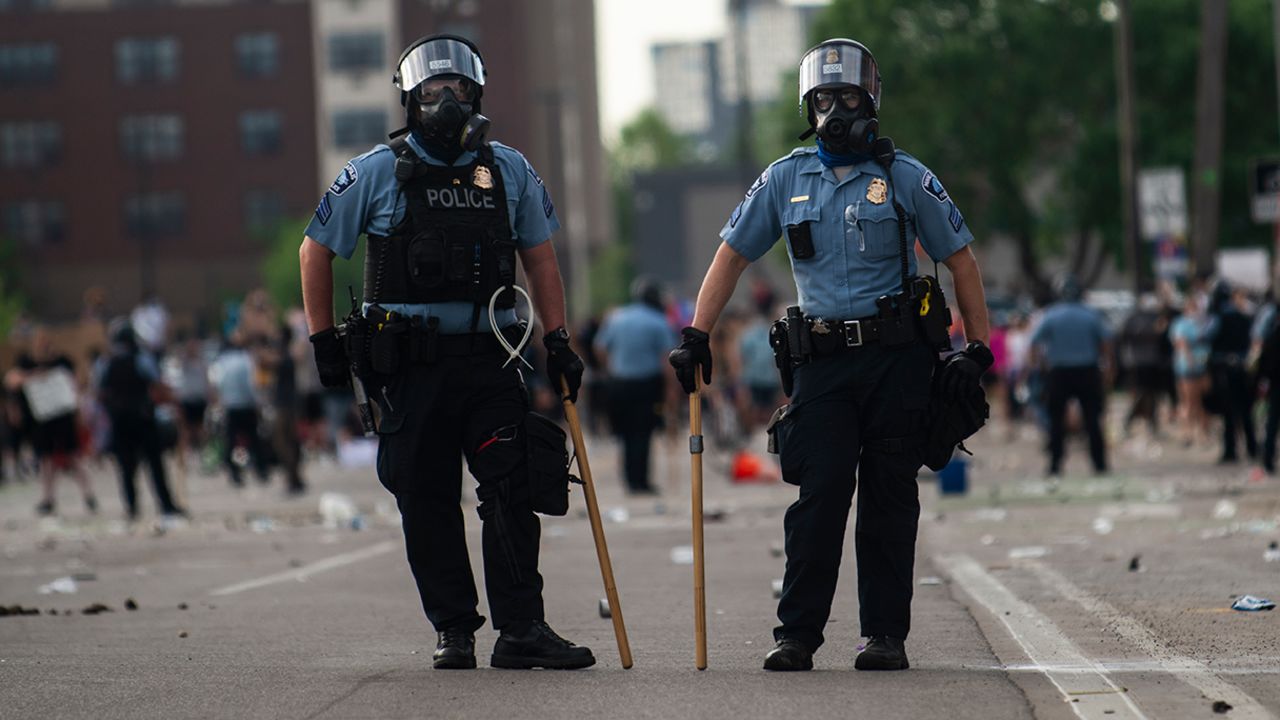 MINNEAPOLIS, MN - MAY 27: Two police officers stand outside the Third Police Precinct during the 'I Can't Breathe' protest on May 27, 2020 in Minneapolis, Minnesota. The station has become the site of an ongoing protest after the police killing of George Floyd. Four Minneapolis police officers have been fired after a video taken by a bystander was posted on social media showing Floyd's neck being pinned to the ground by an officer as he repeatedly said, "I can't breathe". Floyd was later pronounced dead while in police custody after being transported to Hennepin County Medical Center.  (Photo by Stephen Maturen/Getty Images)