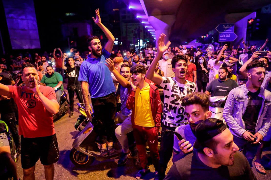 Protesters chant slogans  in the Lebanese capital Beirut's southern suburb late on June 11, 2020. 