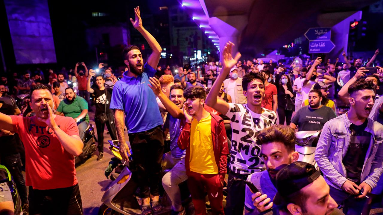 Protesters chant slogans in the Lebanese capital Beirut's southern suburb late on June 11, 2020.