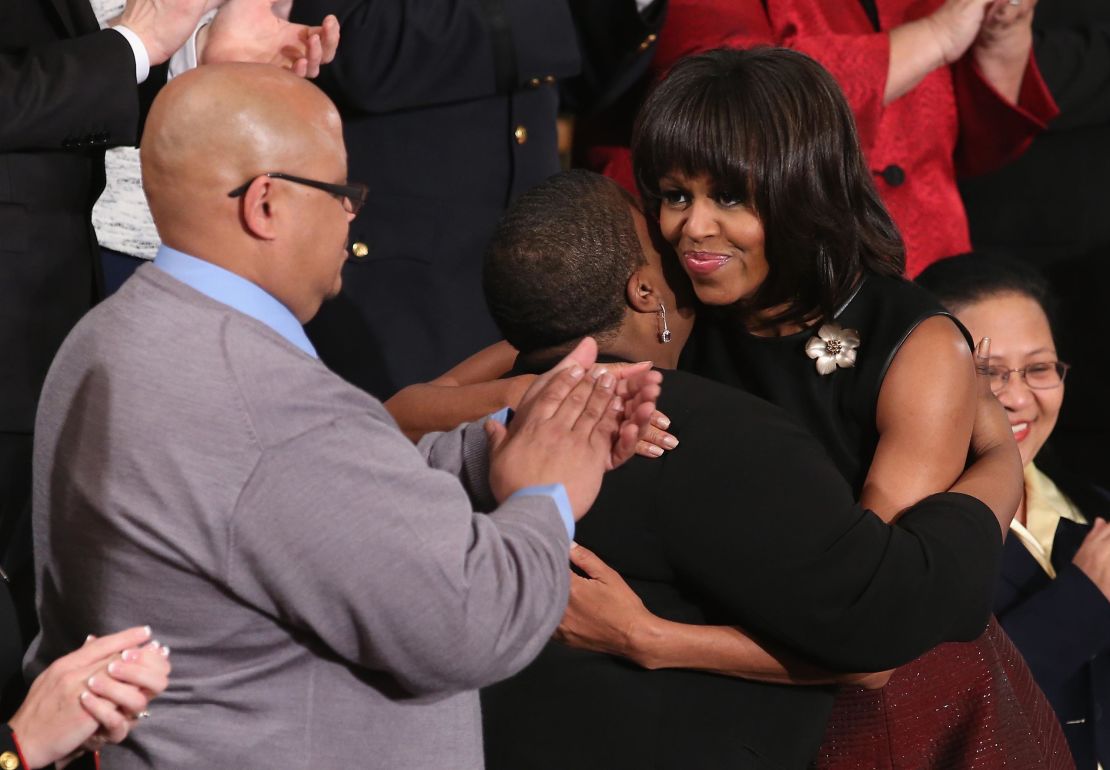 Then first lady Michelle Obama hugs Cleopatra Cowley-Pendleton and Nathaniel A. Pendleton Sr. of Chicago before then President Barack Obama's State of the Union speech at the U.S. Capitol February 13, 2013 in Washington, DC. The Pendleton's daughter, Hadiya Pendleton, was murdered on January 29, 2013, when she was shot and killed in Harsh Park on Chicago's South Side. 