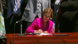 Iowa Gov. Kim Reynolds signs a police reform bill in Des Moines, Iowa, on June 12, 2020.