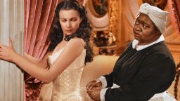 Vivien Leigh (1913-1967), British actress, has her corset tightened by Hattie McDaniel (18921952), US actress, in a publicity still issued for the film, 'Gone with the Wind', 1939. The drama, directed by Victor Fleming (1889-1949), starred Leigh as 'Scarlett O'Hara', and McDaniel as 'Mammy'. (Photo by Silver Screen Collection/Getty Images)