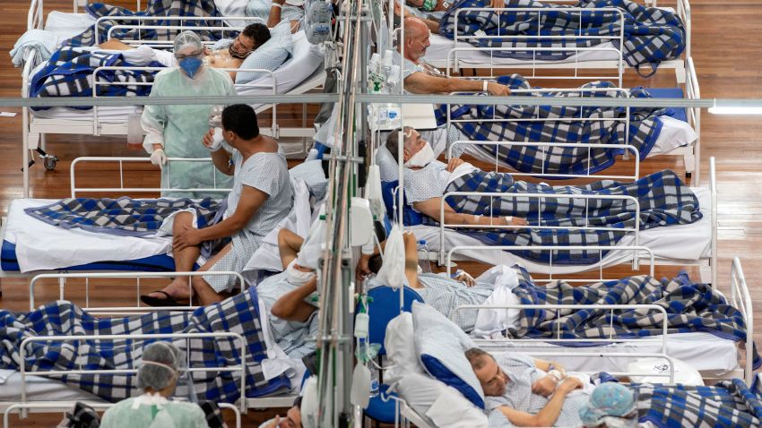 COVID-19 patients lie on beds in a field hospital built inside a gym in Santo Andre, on the outskirts of Sao Paulo, Brazil, Tuesday, June 9, 2020. (AP Photo/Andre Penner)