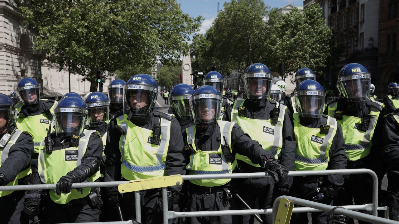 Police form a barrier in front of activists surrounding the Cenotaph on Whitehall in anticipation of clashes with Black Lives Matter protesters.