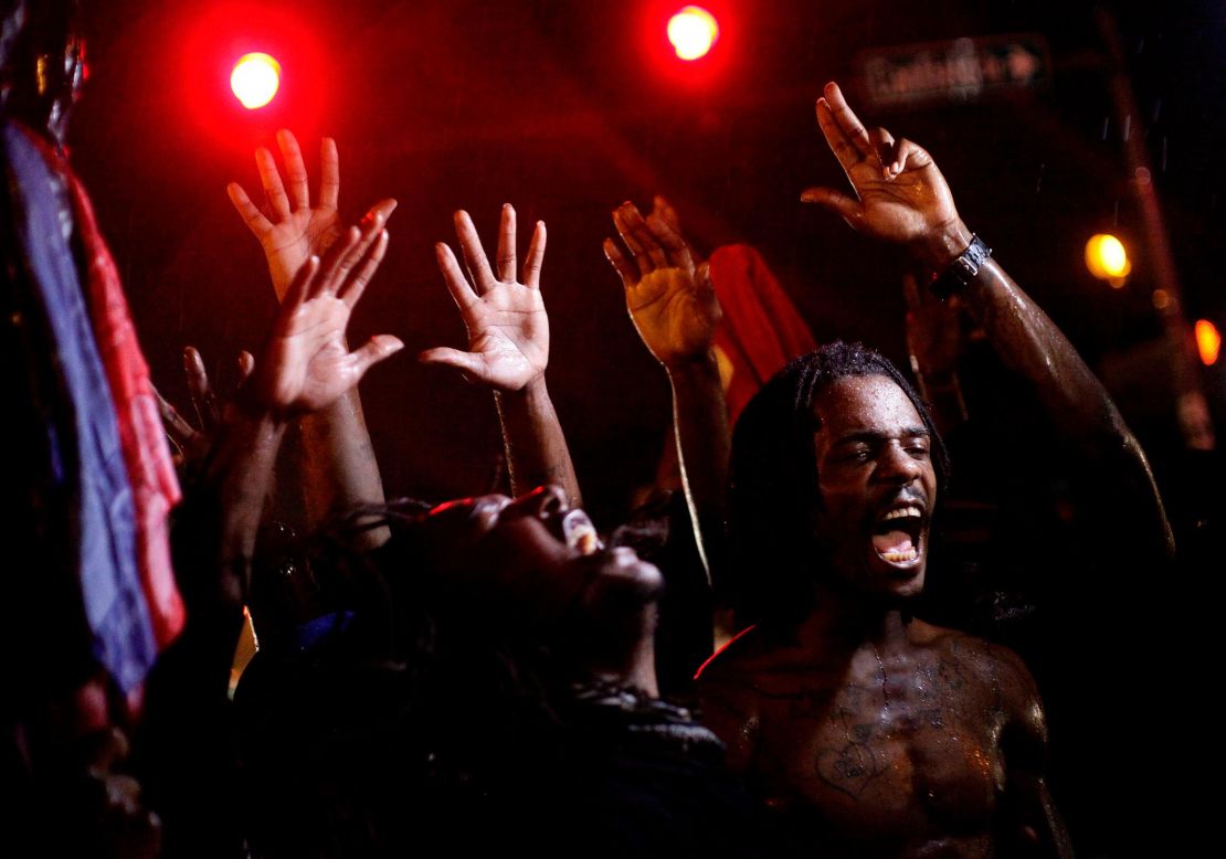 Demonstrators defied a curfew in the streets of Ferguson to protest against the police shooting of Michael Brown in August 2014.