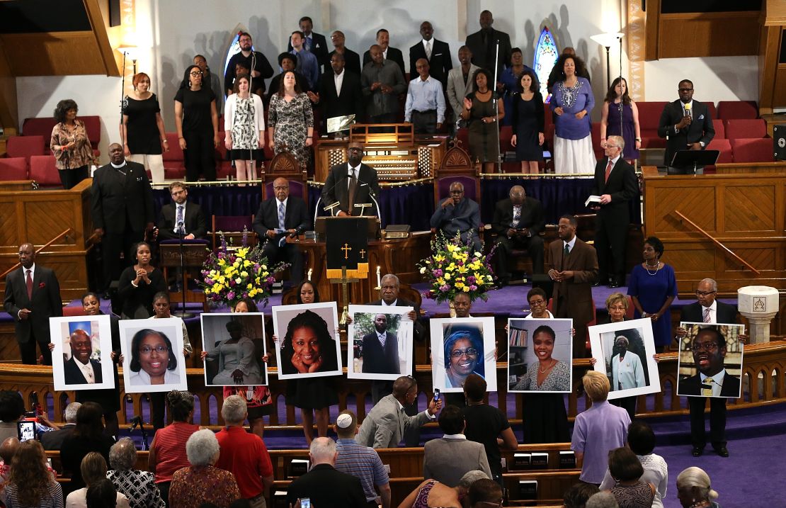 Photos of the nine victims killed at the Emanuel African Methodist Episcopal Church are held up by congregants during a prayer vigil in Washington.