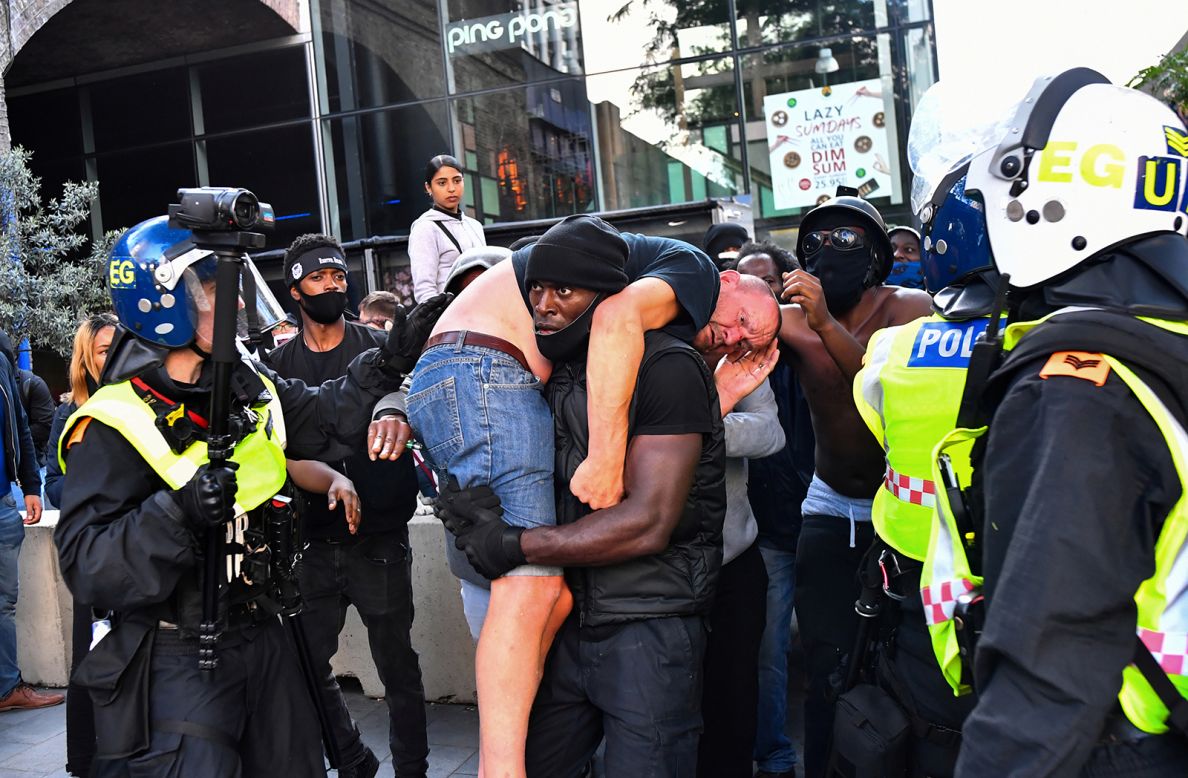 Patrick Hutchinson <a href="https://www.cnn.com/2020/06/18/europe/white-man-black-lives-matter-protester-police-gbr-scli-intl/index.html" target="_blank">carries an injured man to safety</a> during a Black Lives Matter protest in London on Saturday, June 13. The man was allegedly attacked amid violent clashes. Hutchinson told CNN he helped the man because he didn't want the main reason for the protests to be lost in one moment of violence.