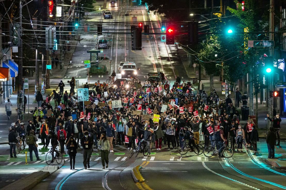 Protesters packed tightly together marched to a police precinct in Seattle on June 9.