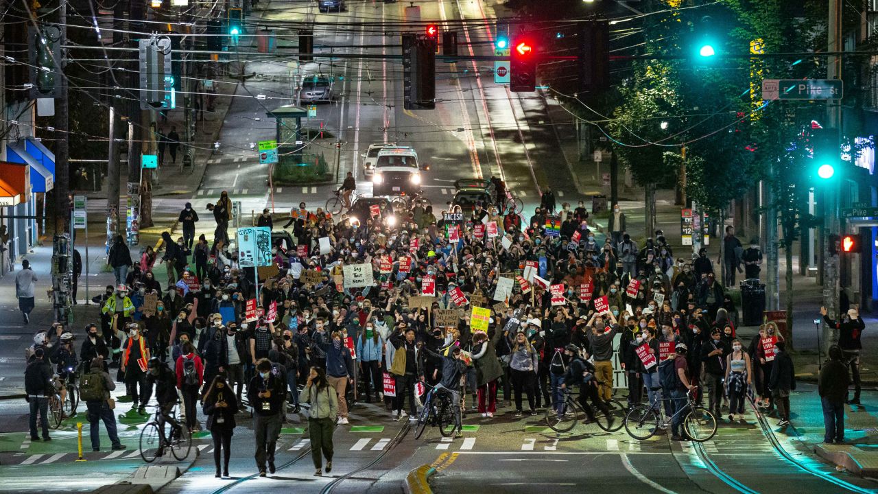 Protesters packed tightly together marched to a police precinct in Seattle on June 9.