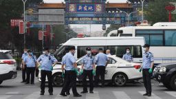 Chinese police guard the entrance to the closed Xinfadi market in Beijing on June 13, 2020. - Eleven residential estates in south Beijing have been locked down due to a fresh cluster of coronavirus cases linked to the Xinfadi meat market, officials said on June 13. (Photo by GREG BAKER / AFP) (Photo by GREG BAKER/AFP via Getty Images)
