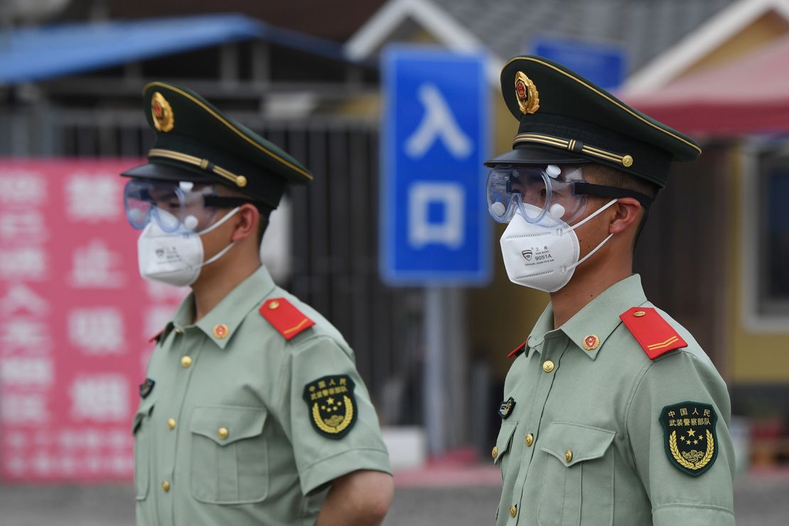 Paramilitary police officers guard the closed Xinfadi market in Beijing.