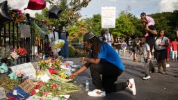 ATLANTA, GA - JUNE 14: A man kneels at the memorial for Rayshard Brooks on June 14, 2020 in Atlanta, Georgia. The memorial is found at the ste of the Wendy's restaurant which was set ablaze overnight. Rayshard Brooks, 27, was shot and killed by police in a struggle following a field sobriety test at the Wendy's on June 12th. (Photo by Dustin Chambers/Getty Images)