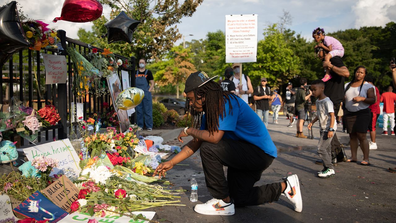 A man kneels at the memorial for Rayshard Brooks on June 14 in Atlanta.