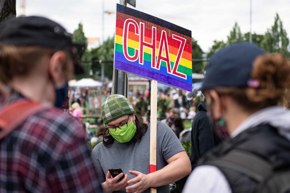 A man holds a sign in the Capitol Hill Autonomous Zone or CHAZ.