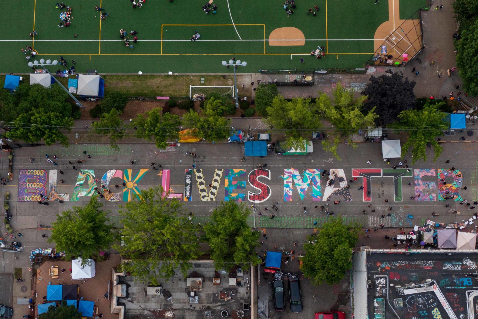 This aerial photo shows a Black Lives Matter mural in Seattle on June 14. Barricades and street graffiti mark the entrance to what's known as Seattle's Capitol Hill Autonomous Zone, which <a href="index.php?page=&url=https%3A%2F%2Fwww.cnn.com%2F2020%2F06%2F15%2Fus%2Fseattle-capitol-hill-autonomous-zone-monday%2Findex.html" target="_blank">protesters have occupied</a> since June 7.