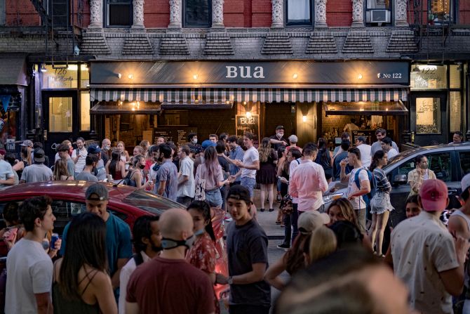 People drink outside a bar in New York City's East Village on June 12. Bars in the city were not allowed to open yet, but many people in New York took to the streets after the city <a href="index.php?page=&url=https%3A%2F%2Fwww.cnn.com%2Finteractive%2F2020%2F06%2Fus%2Fnew-york-coronavirus-reopening-cnnphotos%2Findex.html" target="_blank">entered Phase One of its reopening plan</a> on June 8.