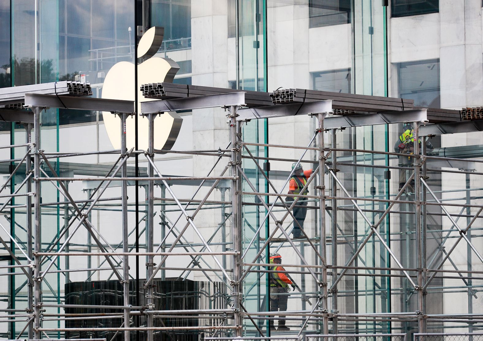 Workers remove the blocks around an Apple Store on New York's Fifth Avenue on June 12. After 78 days of stay-at-home orders — the longest coronavirus lockdown in the country — <a  target="_blank">New York launched Phase One of its reopening plan</a> on June 8. That meant hundreds of thousands of people could get back to work, including nonessential workers in construction and manufacturing. Retail stores could set up curbside or in-store pickups.