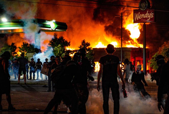Demonstrators set fire to a Wendy's restaurant in Atlanta on June 13. Rayshard Brooks, a 27-year-old Black man, <a href="index.php?page=&url=https%3A%2F%2Fwww.cnn.com%2F2020%2F06%2F14%2Fus%2Frayshard-brooks-atlanta-shooting%2Findex.html" target="_blank">was fatally shot by police</a> near the restaurant's drive-thru on June 12. Brooks was shot after police moved to handcuff him for suspected driving under the influence, according to videos from the scene. The videos show that Brooks took an officer's Taser during the attempted arrest and then fired the Taser at the officers as he ran away. One officer then fatally shot Brooks three times with his service weapon, authorities said. Brooks was shot twice in the back, according to a release by the Fulton County Medical Examiner's Office. The police officer who killed Brooks, Garrett Rolfe, was charged with murder. Rolfe's attorneys say he was legally justified and acting in self-defense. Atlanta's police chief resigned.