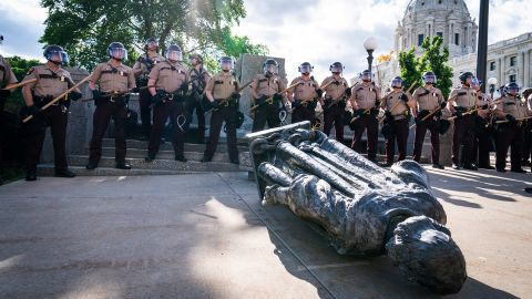 State troopers surround the statue of Christopher Columbus after it was toppled in front of the Minnesota State Capitol on June 10. 