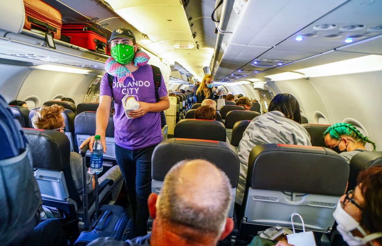 Passengers board an American Airlines flight to Charlotte, North Carolina, at San Diego International Airport on May 20. Tensions can rise between passengers who wear a face mask and those who don't.