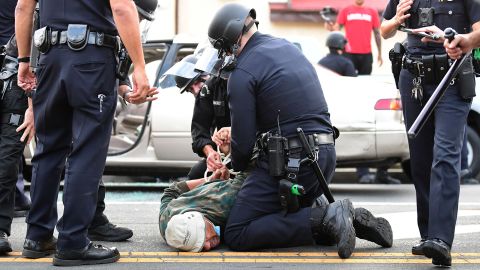 A man is arrested by Los Angeles police officers for violating curfew in Hollywood, California on June 2.