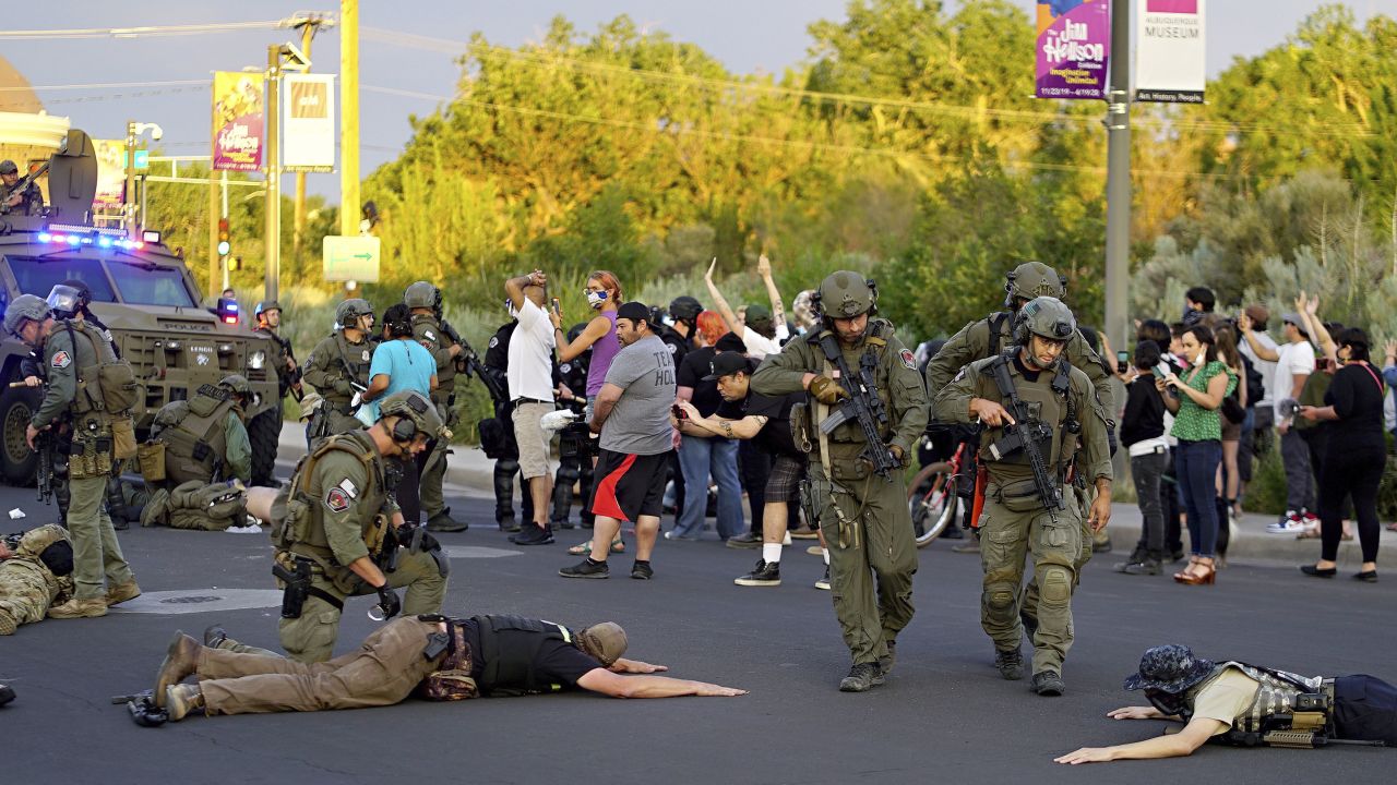 Albuquerque police detain members of the New Mexico Civil Guard, an armed civilian group, on Monday.