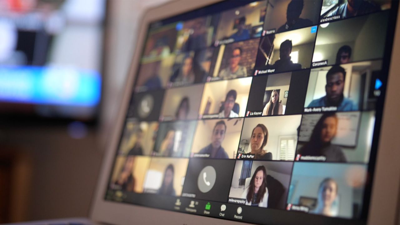 Researchers from Fajgenbaum's lab gather in a video call to discuss Covid-19 treatment data.