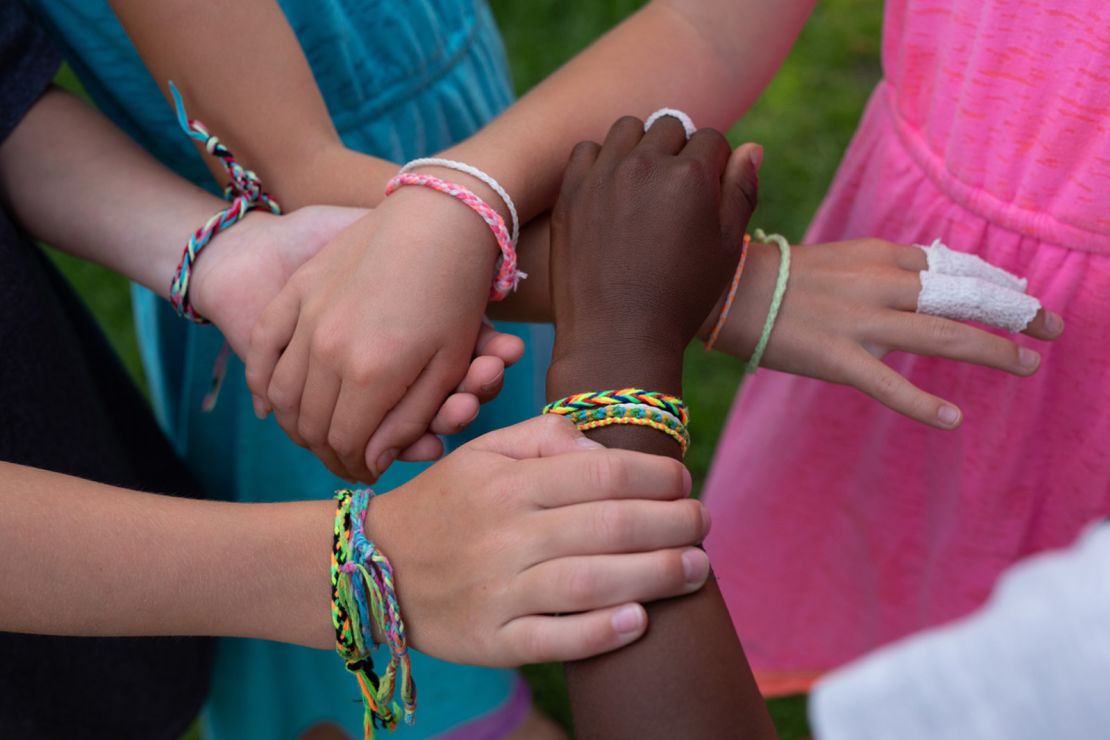 Kamryn and friends wearing friendship bracelets they made.