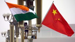 Workers put up the Indian flag (L) alongside the Chinese flag on Tiananmen Square in Beijing, 22 June 2003, ahead of Indian Prime Minister Atal Behari Vajpayee's arrival. Vajpayee's visit is the first to China by an Indian premier in a decade, as the two Asian giants which account for a third of the world's population, have had unsteady relations since a bloody 1962 border war, while fifteen rounds of talks since the 1980s have failed to resolve their boundary disputes.     AFP PHOTO (Photo by - / AFP) (Photo by -/AFP via Getty Images)