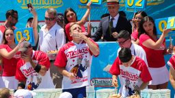 NEW YORK, NY - JULY 04:  Joey Chestnut (C) eats during the men's hot dog eating contest on July 4, 2019 in New York City. Nathan's held its first hot dog eating contest in Coney Island on July 4, 1916. (Photo by Kena Betancur/Getty Images)