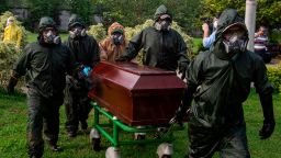 Gravediggers carry a coffin during a funeral at the Jardines del Recuerdo Cemetery in Managua on June 5, 2020, amid the new coronavirus pandemic. (Photo by INTI OCON / AFP) (Photo by INTI OCON/AFP via Getty Images)