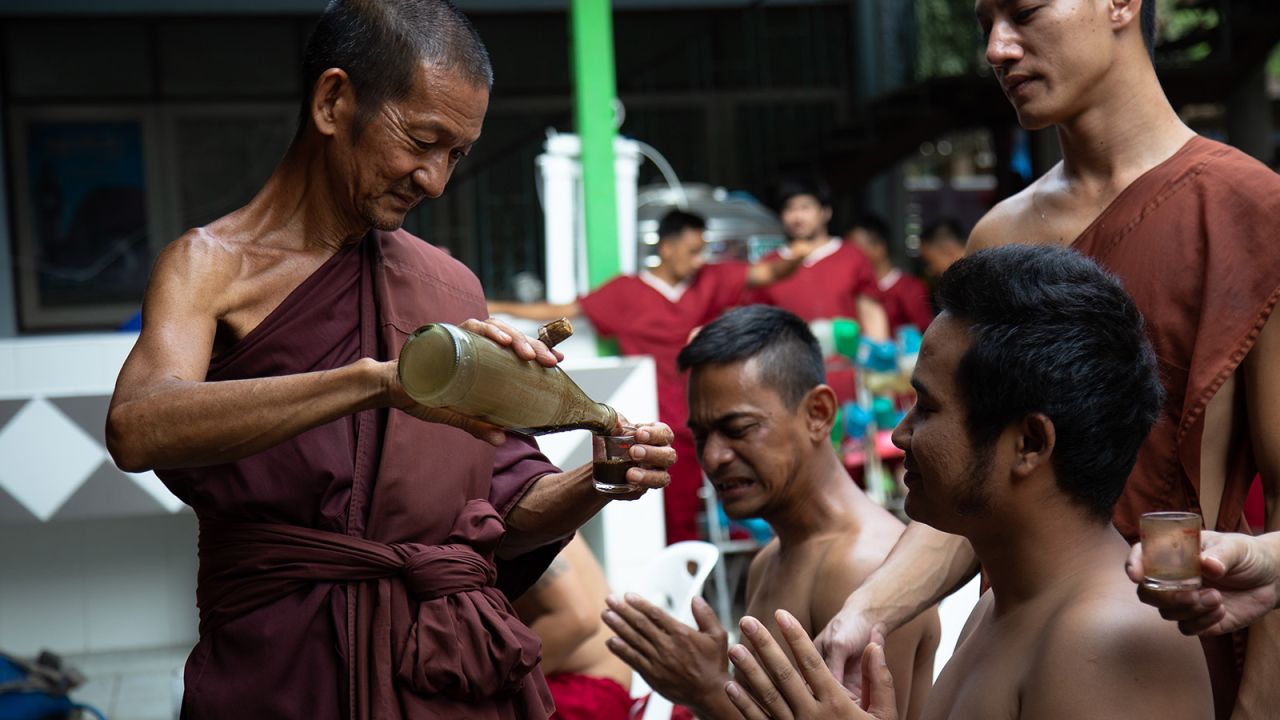 <strong>Purging liquid: </strong>The temple herbalist gives the patients a shot glass of the purging liquid, which one of his assistants pours down their throats.