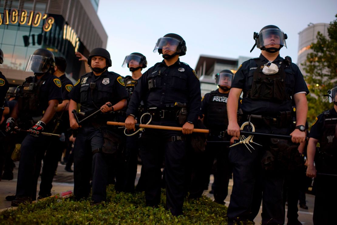 Police officers stand guard after a peaceful march to mourn the death of George Floyd in downtown Houston, Texas on June 2.