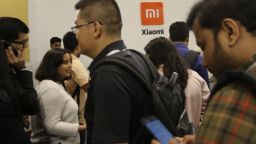 Guests crowd to check out Xiaomi's newly launched products at an event in Bangalore, India, Tuesday, Sept. 17, 2019. Chinese electronic major Xiaomi launched a new range of smart televisions, fitness bands and home products Tuesday. (AP Photo/Aijaz Rahi)