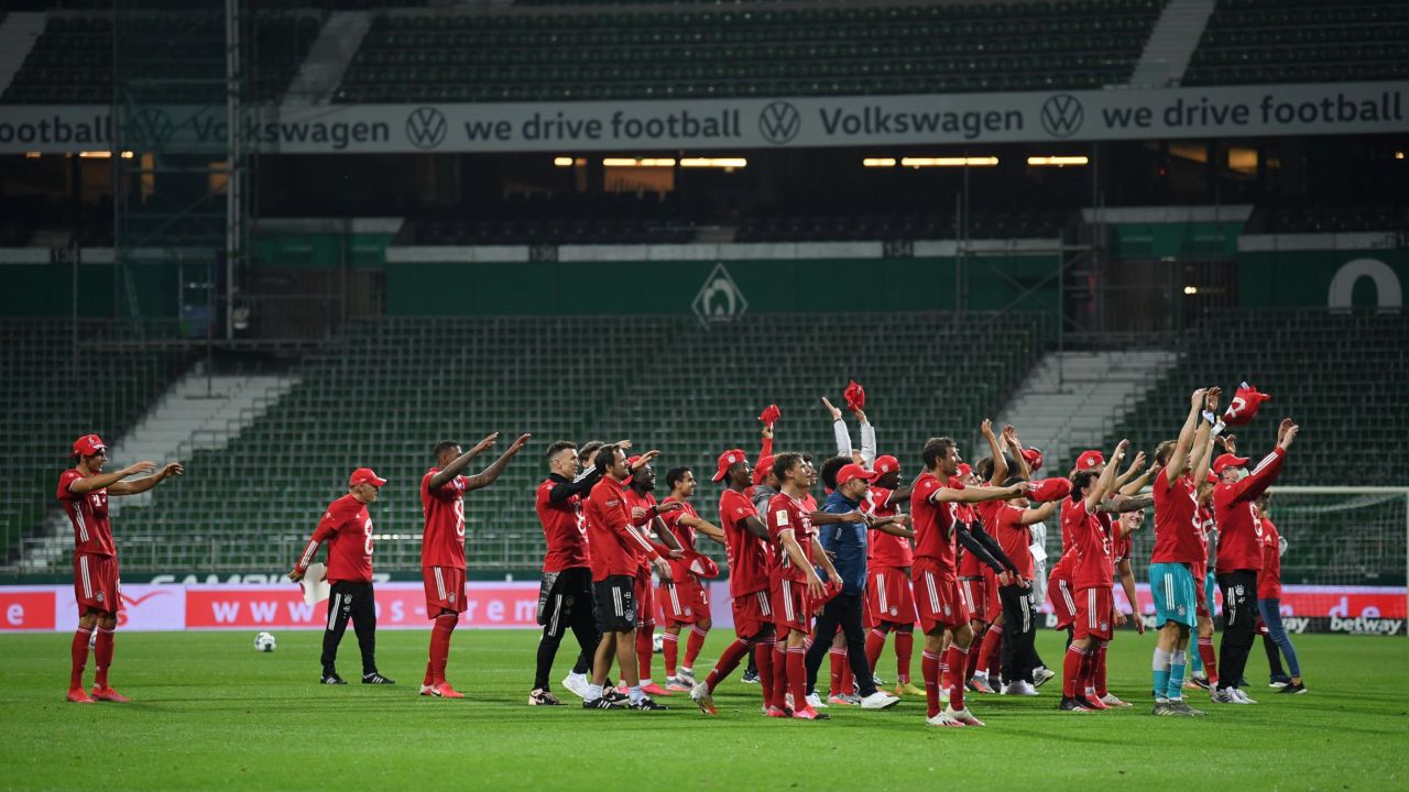 Bayern Munich players celebrate their eighth straight title inside the empty Weserstadion.