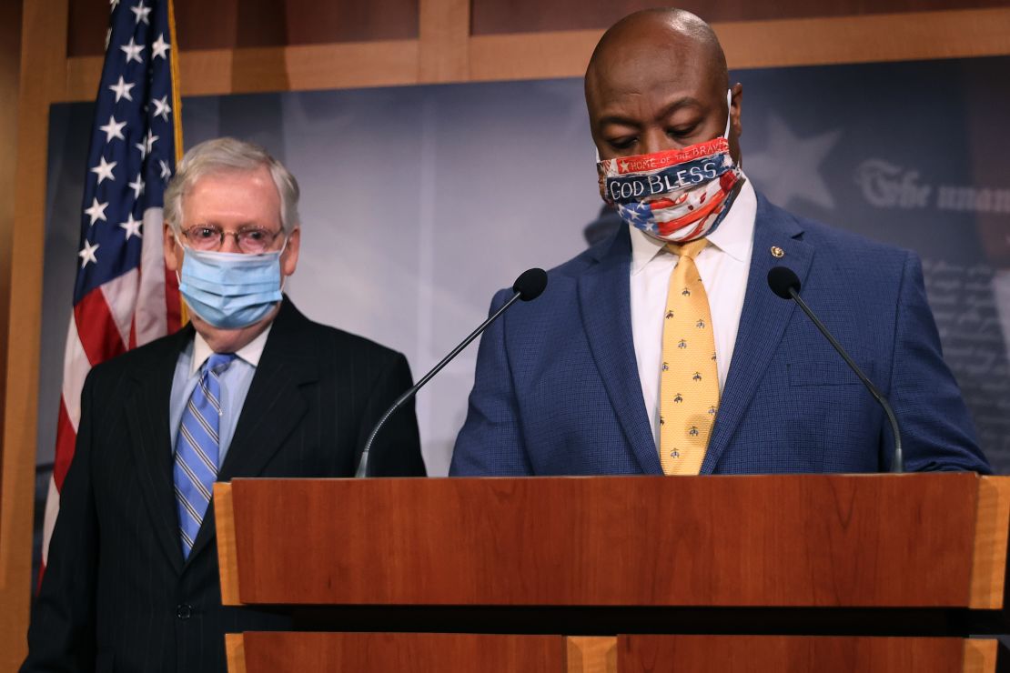 Sen. Tim Scott, at right, a South Carolina Republican, and Senate Majority Leader Mitch McConnell take the podium for a news conference Wednesday on Capitol Hill.