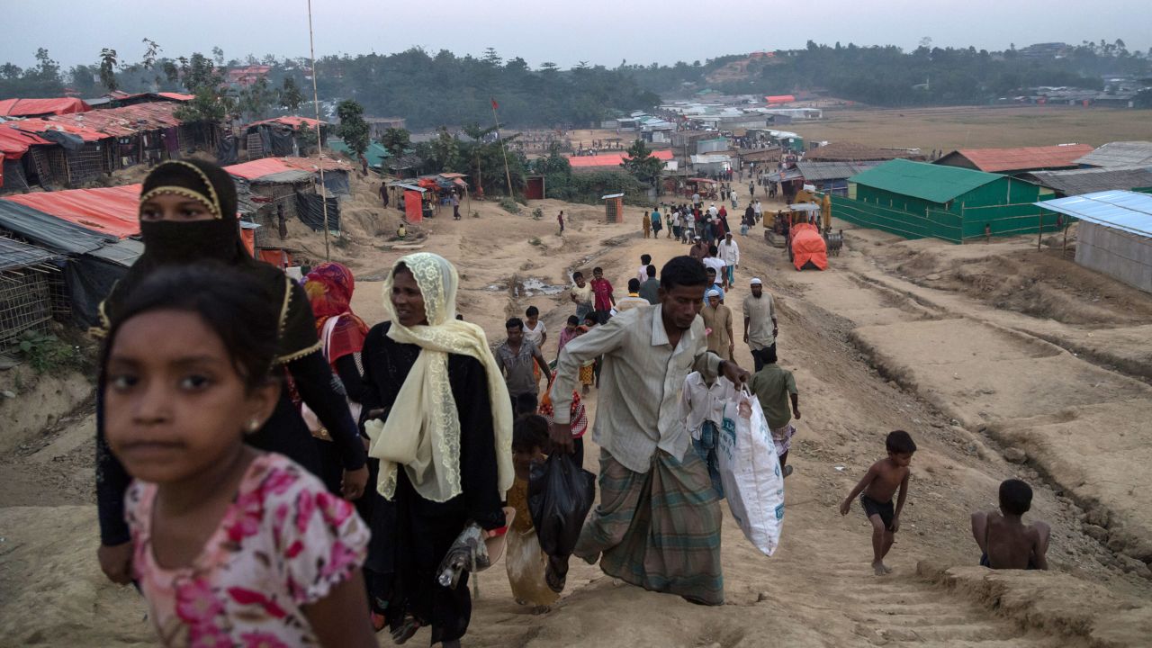 Rohingya Muslim refugees walk along a path inside the Thankhali refugee camp in Cox's Bazar on November 25, 2017.
Rohingya refugees who return to Myanmar from Bangladesh following a repatriation agreement will initially live in temporary shelters or camps, Dhaka said November 25, a day after the UN raised concern for their safety when they go back. The United Nations says more than 620,000 Rohingya have fled to Bangladesh since August and now live in squalor in the world's largest refugee camp after a military crackdown in Myanmar that the UN and Washington have said clearly constitutes "ethnic cleansing". / AFP PHOTO / Ed JONES        (Photo credit should read ED JONES/AFP via Getty Images)
