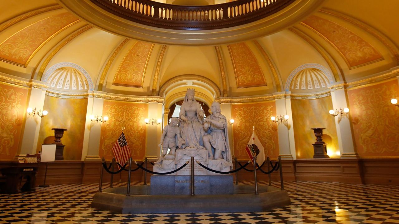 In this March 18, 2020, file photo, a statue of Queen Isabella and Christopher Columbus stands in the rotunda of the Capitol in Sacramento, Calif. 