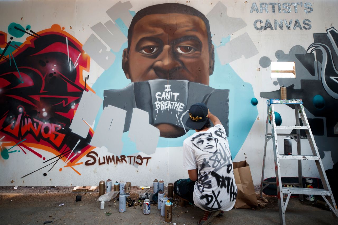 Paul Glyn-Williams puts the finishing touches on a Floyd mural in Toronto on June 6.