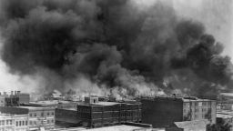 Black smoke billows from fires during the Tulsa Race Massacre of 1921, in the Greenwood District, Tulsa, Oklahoma, US, June 1921. 
