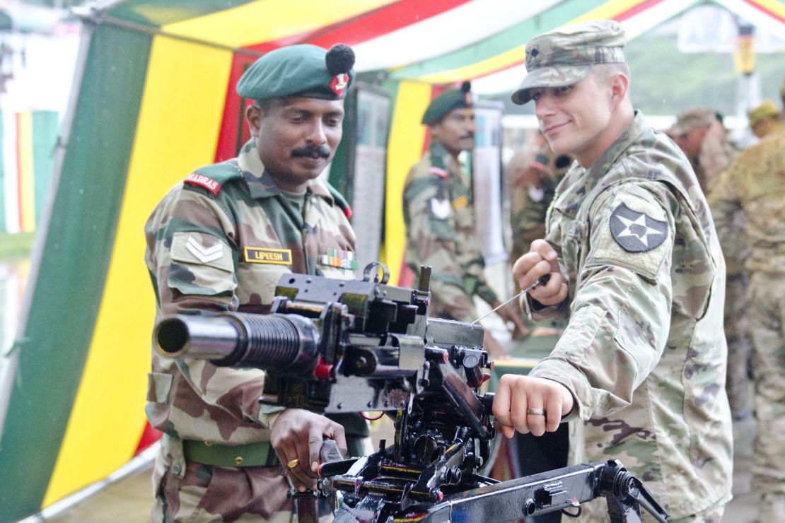An Indian soldier showcases a grenade launcher to a US soldier on Sept. 15, 2016, at Chaubattia, India.