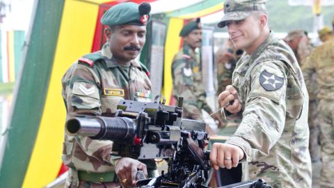 An Indian soldier showcases a grenade launcher to a US soldier on Sept. 15, 2016, at Chaubattia, India.