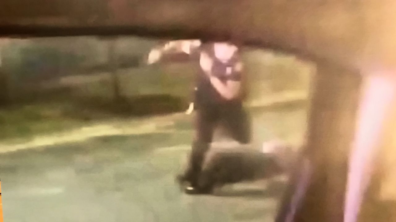 This still image taken from a bystander's video shows former officer Garrett Rolfe kick Rayshard Brooks after he was shot, according to Fulton County District Attorney Paul Howard.