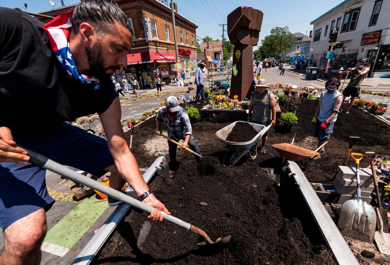 Members of Spark-Y, a nonprofit youth empowerment group, build a garden at the George Floyd memorial site in Minneapolis on June 17.