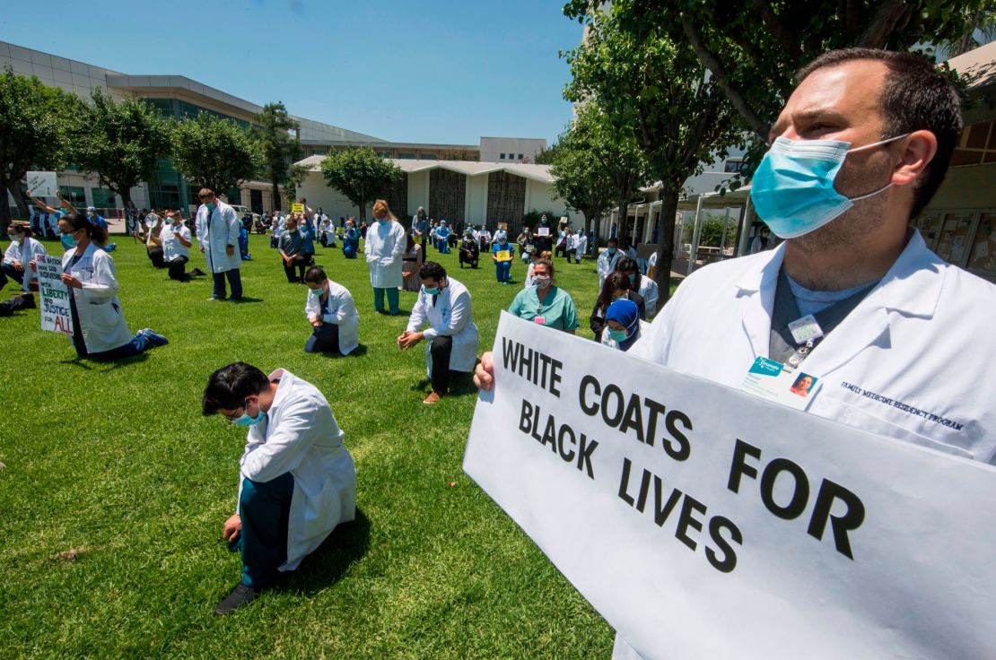 Health care workers in West Covina, California, kneel in solidarity with protesters June 11.
