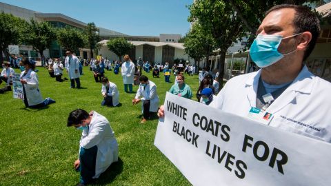 Health care workers in West Covina, California, kneel in solidarity with protesters June 11.
