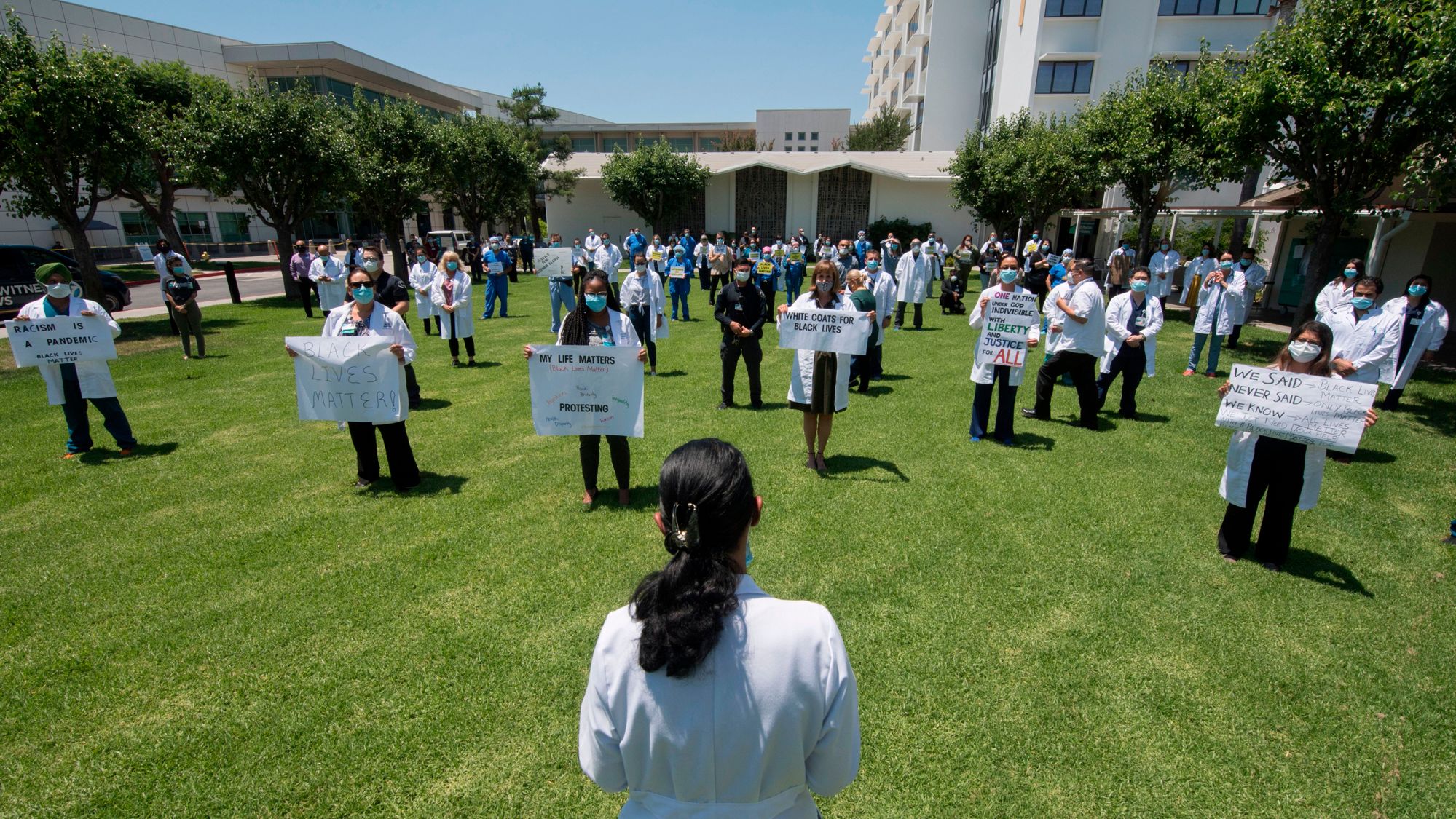 Doctors, nurses and other health care workers participate in a White Coats for Black Lives event in solidarity with George Floyd and other black Americans killed by police officers on June 11 at the Queen of the Valley Hospital in West Covina.