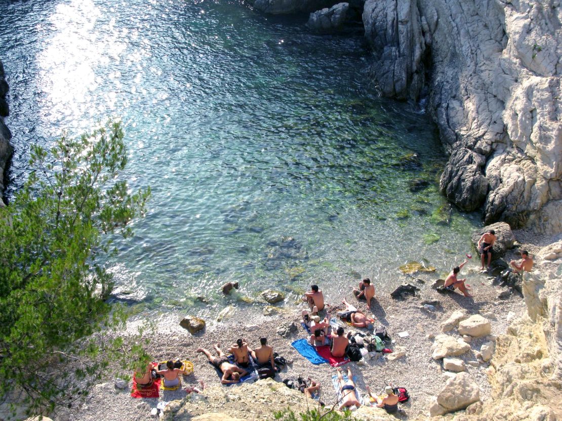 It was completely against the law to scramble down the dangerous cliffs to the water in Marseille, France. Even moms with little children ignored the signage.